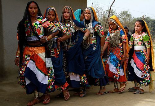 Tharu women performing a traditional cultural dance in a village setting
