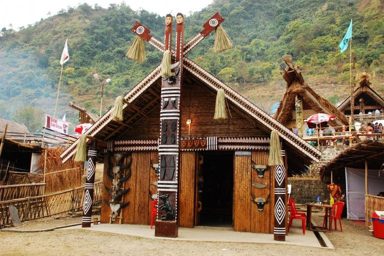 A traditional Tamang village house with prayer flags and a stupa in the Langtang Valley