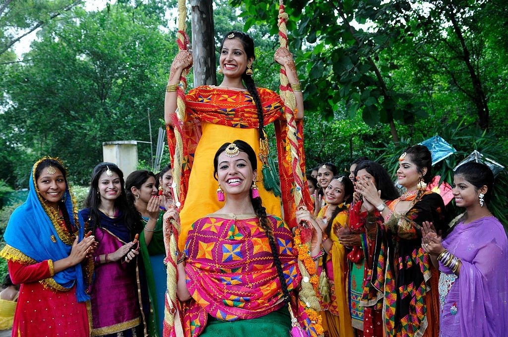 Vibrant crowds of women dressed in elegant red, singing and dancing at Pashupatinath Temple during Teej