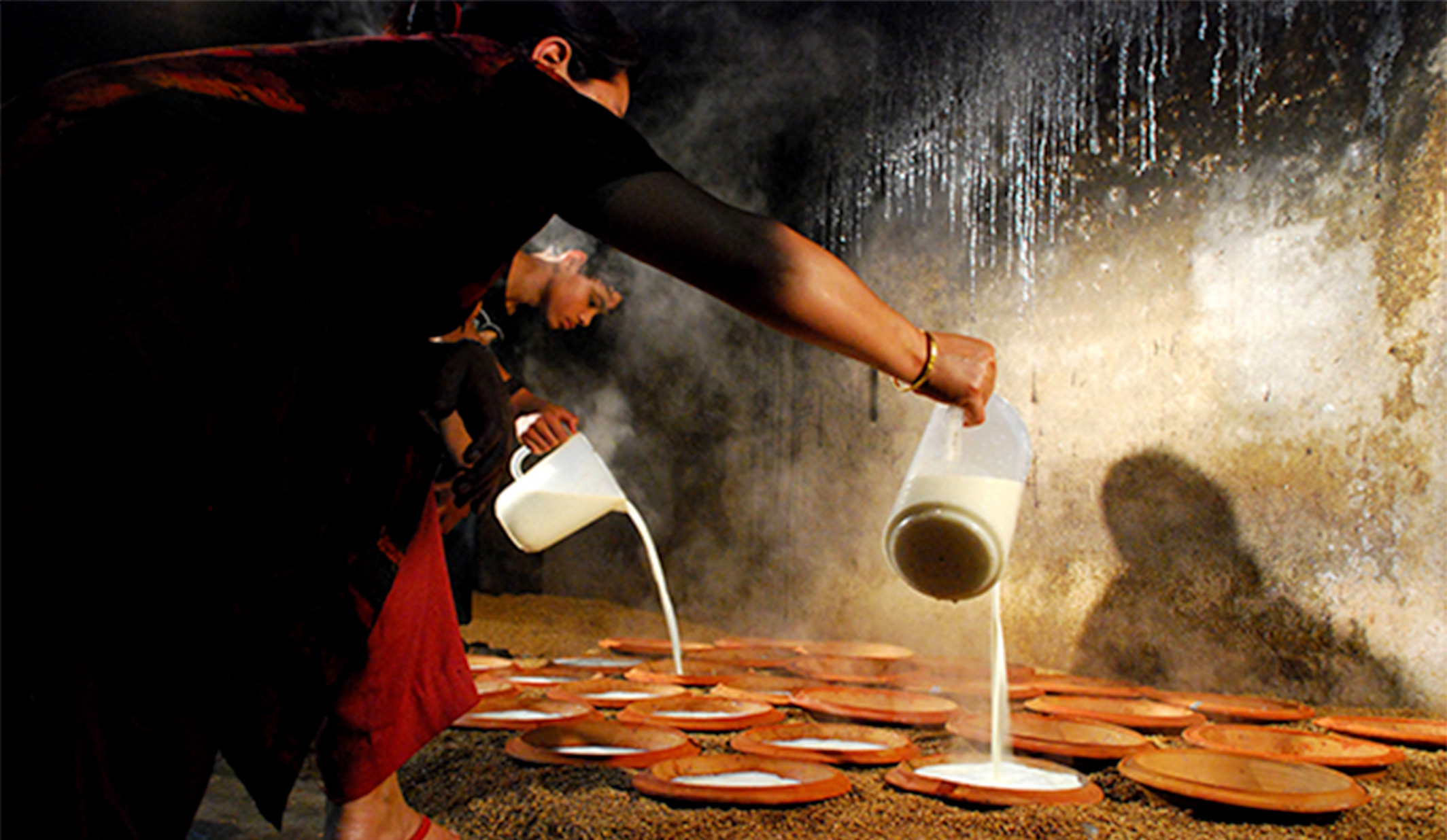 Vendors doling out pots of Juju Dhau at Bhaktapur’s market during a festival.