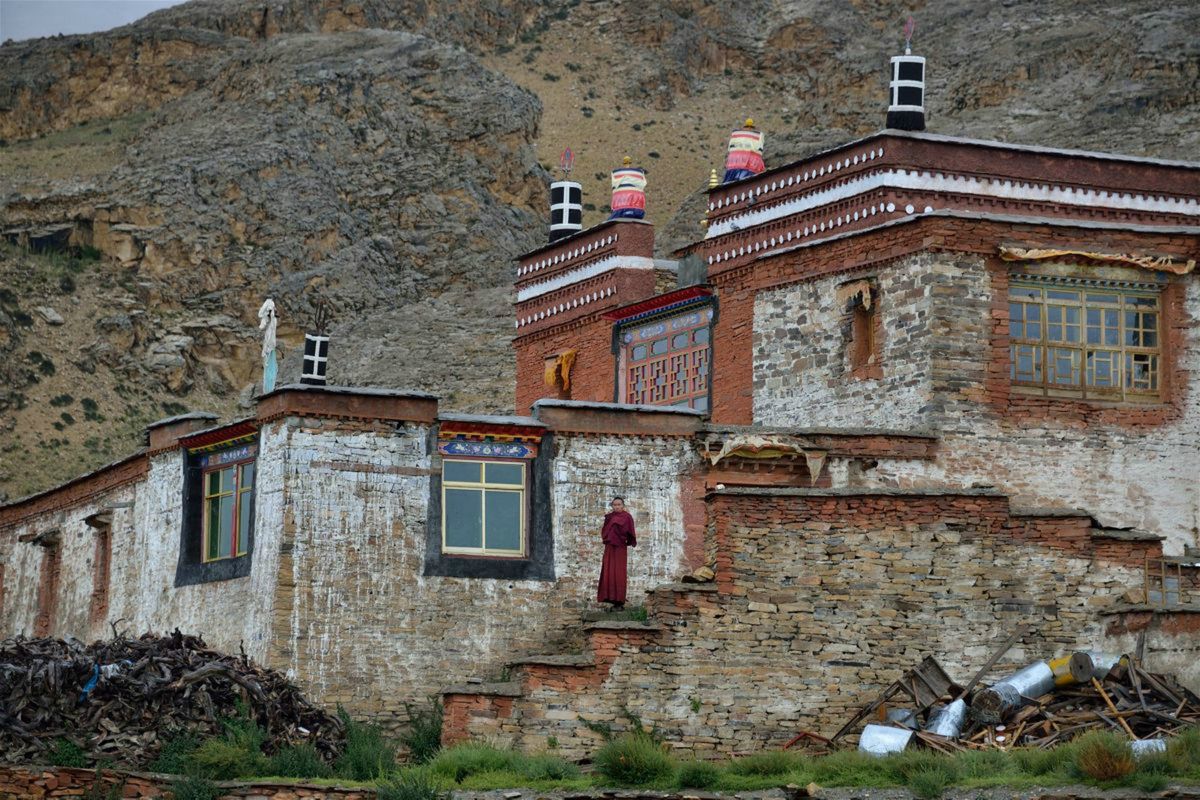 A traditional Tibetan-style stone village (Ringmo) nestled near a hillside in Dolpo