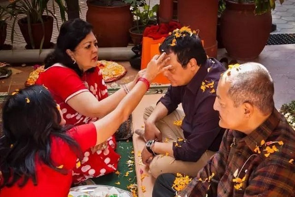 Family receiving blessings with Tika and Jamara during Dashain ceremony